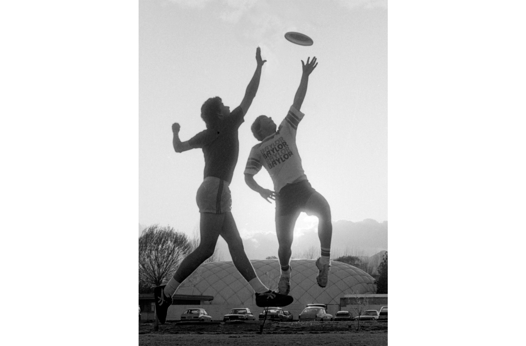 flatballwizards_bkg two college students catch a frisbee against a setting sun