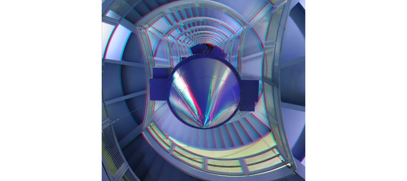 A stereo image looking up a modern stairway with a large blue cone pointing at the viewer.