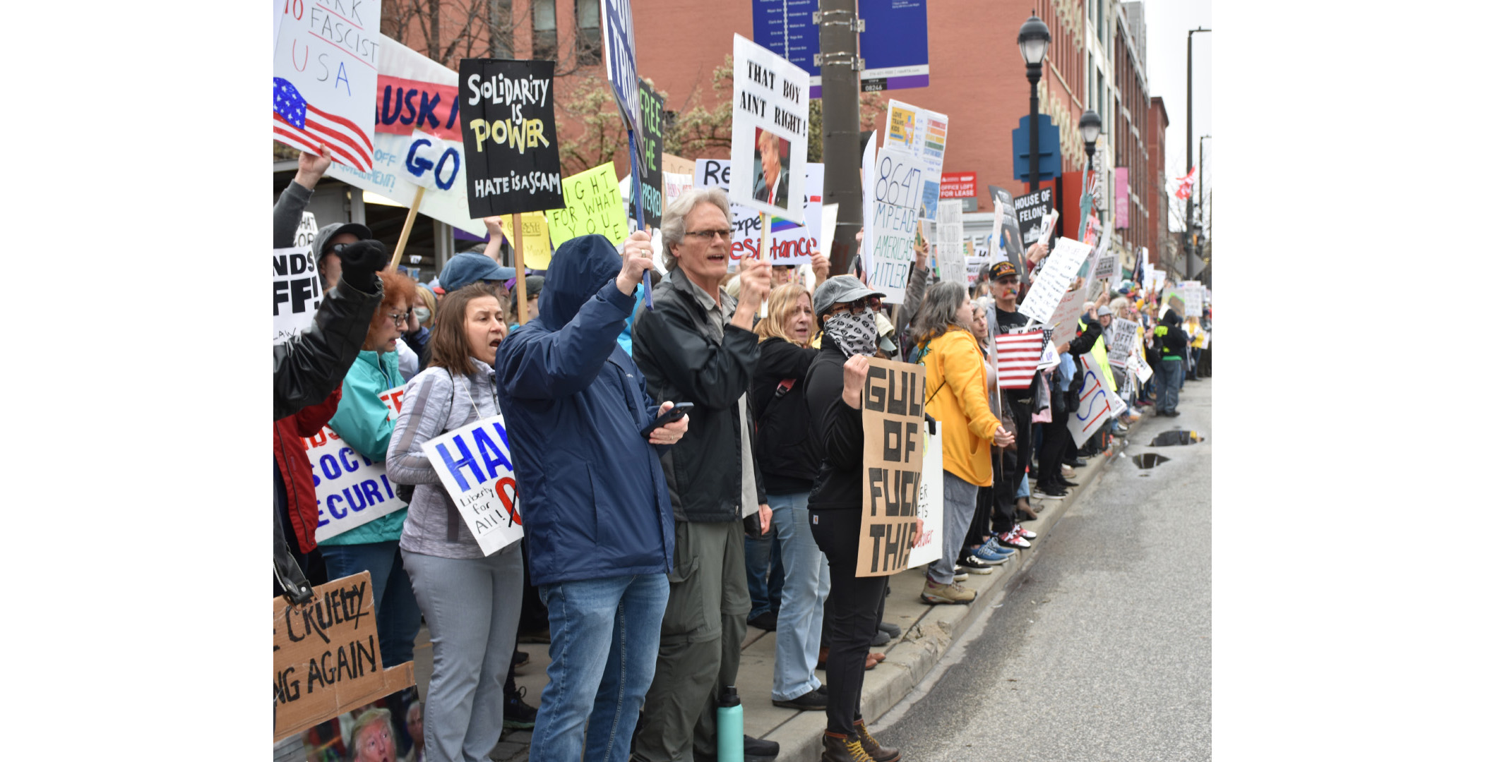 handsoff_protest2 An image from a the long line of people lining the streets of Cleveland near the West Side Market, holding signs protesting the Trump administration. An image from a the long line of people lining the streets of Cleveland near the West Side Market, holding signs protesting the Trump administration.
