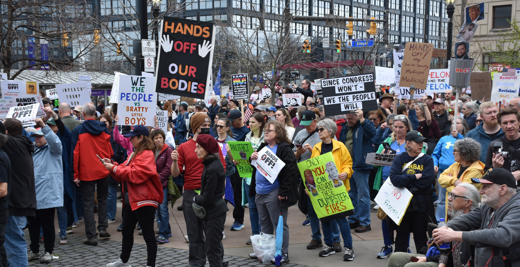 handsoffourbodies A shot of the crowd at the protest looking across Cleveland's Market Square. It shows hundreds of people, many, many holding siges. The most prominent sigh says "Hands Off Our Bodies" and another bigger one a little further back saying "We the People vs Bratty little Boys" and another saying "Since Congress Won't - We the People Will"