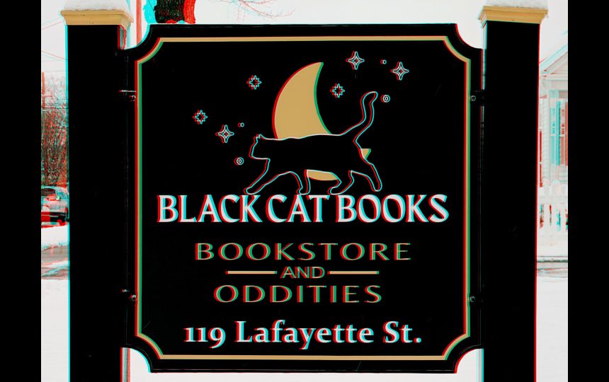 Stereo Anaglyph image of the sign in front of Black Cat Books and Oddities